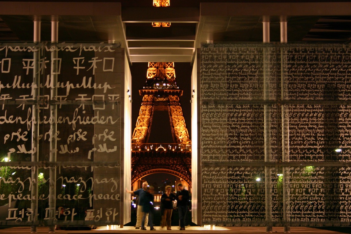 The Eiffel Tower at night through the Wall of Peace
