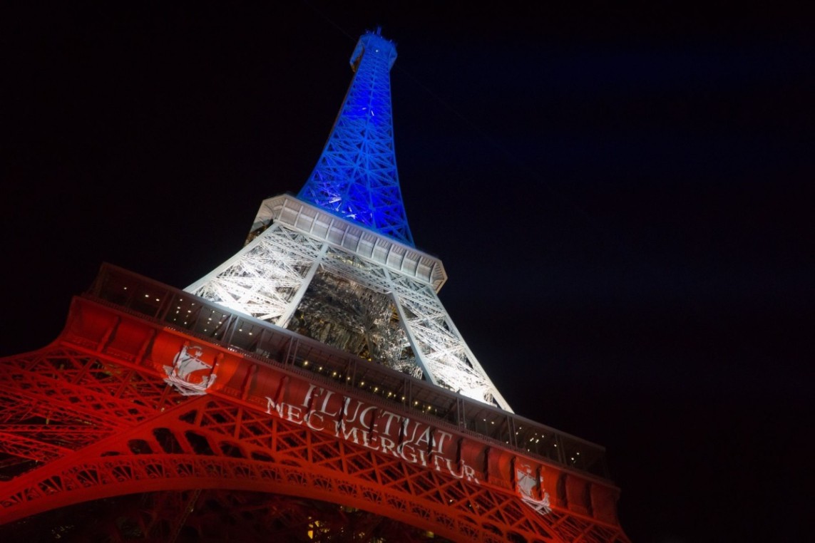 Eiffel Tower lit up in blue, white, and red